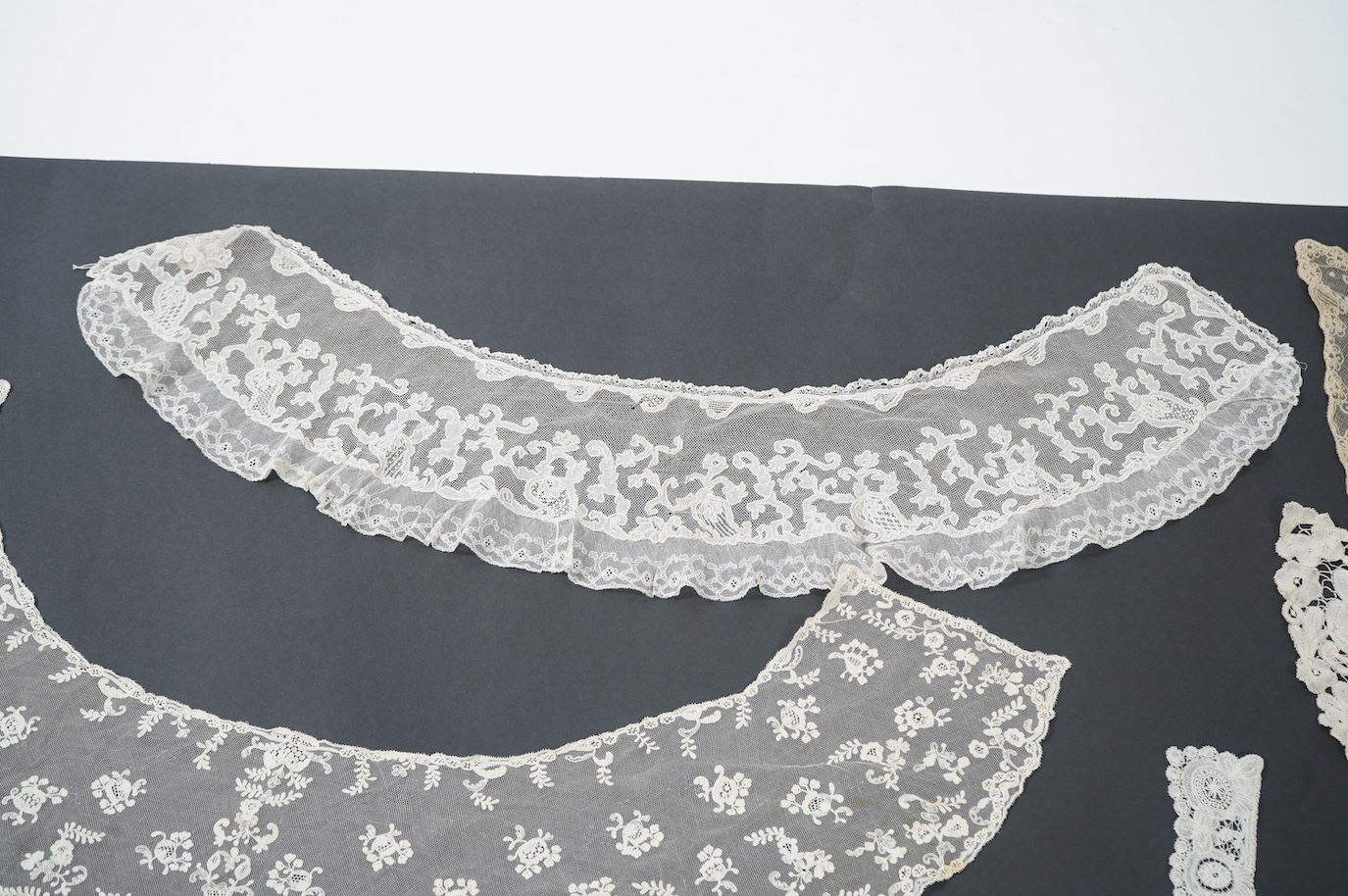 Seven late 19th century collars and trimming, being a long wide length of bobbin lace trimming - 268cm, two similar Bruges cream lace collars, an Irish Carrick-ma-cross collar, a fine needle run collar and another with a